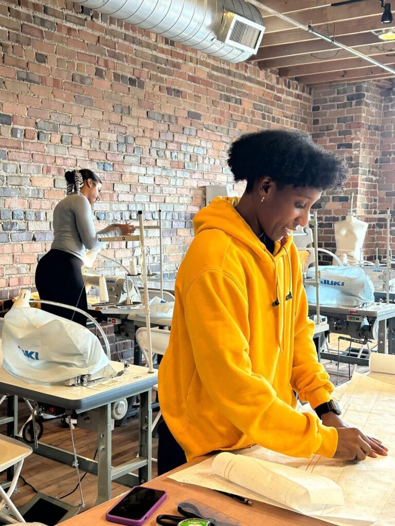 Le Fashion Lab student pressing a garment in the Atlanta studio