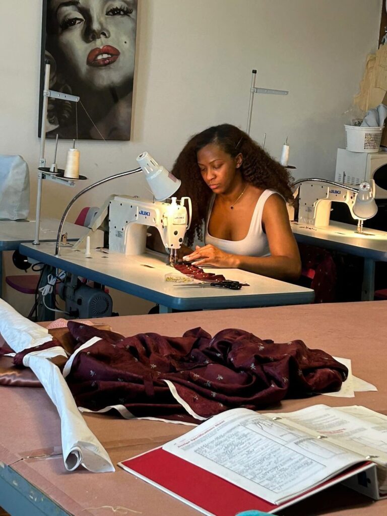 Le Fashion Lab student working at a sewing machine in the Atlanta alterations studio